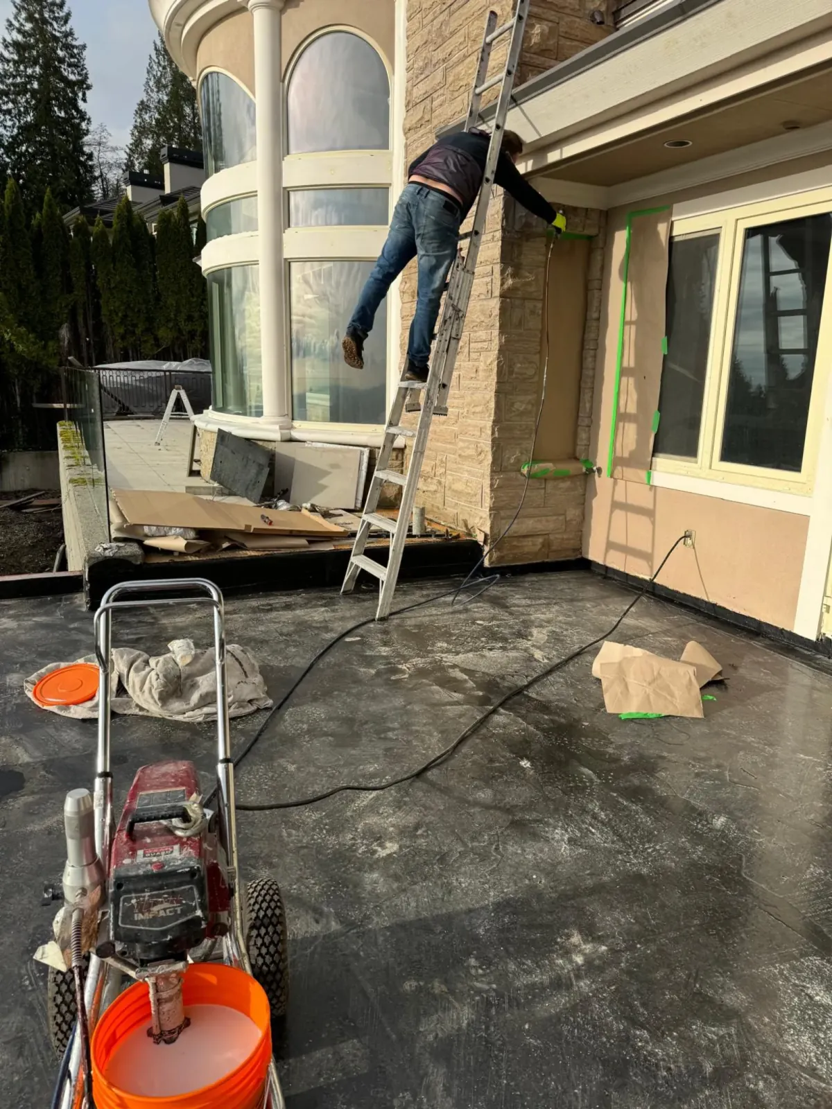 Technician checking building expansion joints and checking envelope leaks.